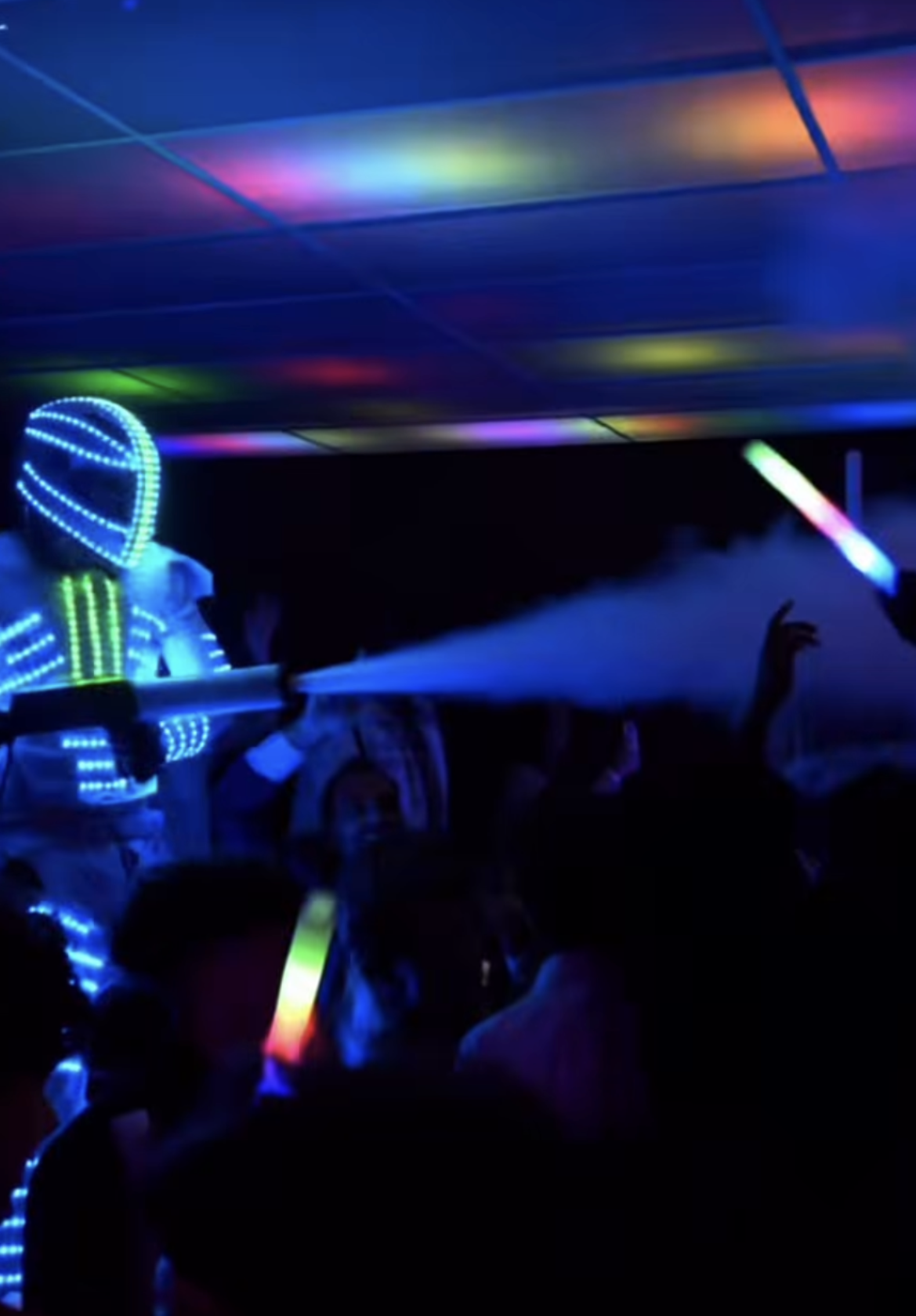 LED performer shooting a CO₂ fog cannon over guests at a celebration