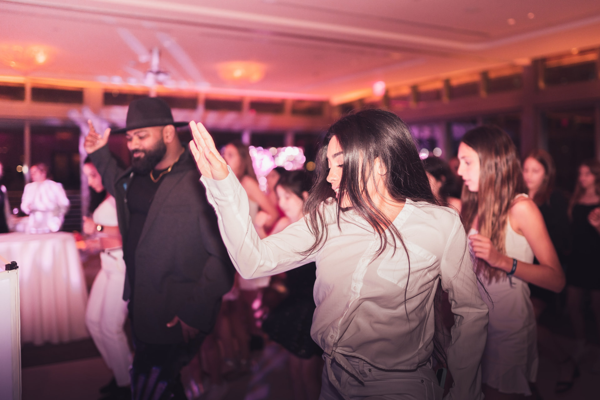 Dancers energizing a packed celebration dance floor