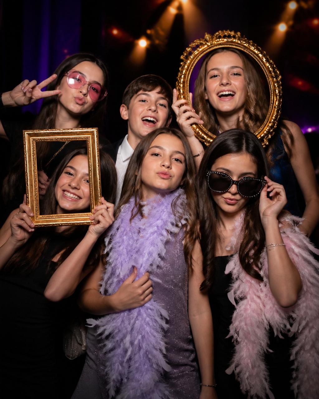 Kids posing with photo booth props at a Mitzvah